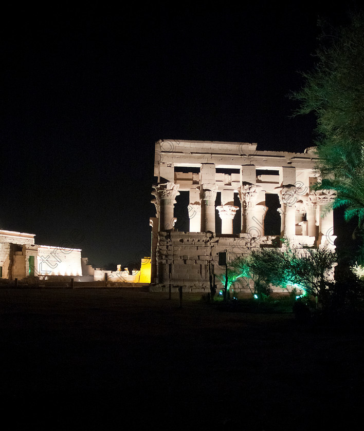 Philae Light Show EG052906JHP 
 Ancient Philae Temple Modern Light Show Trajan Kiosk Aswan Egypt in which, during the first section, spectators walk through the temple with areas highlighted at each stop but the time to take photographs is limited. The second part of the evening is seated and photography is very easy, a tripod is permitted and necessary for time exposures to be made as flash on cameras is almost pointless and more of a nuisance for other viewers. This Sound & Light Show is perhaps the most spiritual of those shown at other centres especially with the trip at night by boat to the island and the peacefulness that naturally surrounds this location. 
 Keywords: Egypt, Egyptian, Aswan, River Nile, Agilkia Island, island, Philae, temple, light, sound, show, upright, Trajan, kiosk, Son, Lumiere, spectacular, fantasy, dramatic, night, dark, stars, colours, colors, colourful, colorful, spiritual, surreal