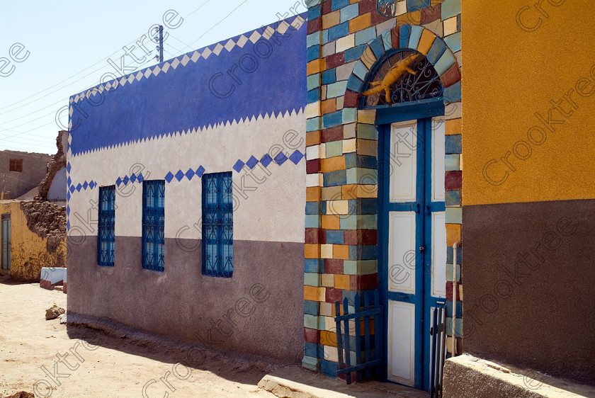 Nubian Painted House EG052597JHP 
 Egypt Seheil Island Nubian Village Painted House Patterns Street Photograph with its genuine sense of colour and distinctive desert shapes for buildings that remain cool in the heat of southern Egypt on this island near Aswan amongst the River Nile cataracts. The main reason for this private excursion by motorboat was to visit the rock carvings which cover this boulder strewn part of the Nile recording many events throughout the ancient history of the Egyptian Empire spanning some 3000 years. 
 Keywords: Egypt, Aswan, River Nile, Seheil, Sehel, Island, Nubia, Nubian, village, natural, houses, homes, domestic, doors, street, landscape, Egyptian, colours, colors, colourful, colorful, painted, bricks, mudbrick, cool, shapes, architecture