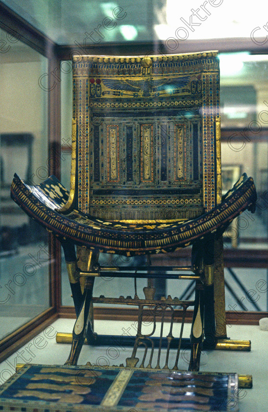 Tut Ceremonial Seat EG11708JHP 
 Egyptian Museum Exhibit folding stool backrest ceremonial chair Tomb Tutankhamun now in the prime antiquities collection in Cairo taken during visits between 1994 and 1996 when photography was allowed albeit without flash and tripod. None is of studio quality, being handheld with existing, usually extremely poor light and using slide film, pushed Fuji 400asa to get a suitable aperture and shutter speed. Most of the photos are from the Tutankahum exhibits while the rest are items that interested me as I explored this wonderful and extensive collection, requiring many more hours if not days and is only hinted at during the usual one or two hour visit made on a package tour. 
 Keywords: Egypt, Cairo, Egyptian, Museum, Tutankhamun, ceremonial, inlaid, seat, ebony, ivory, gold, leaf, glass, paste, semi-precious, stones, folding, stool, Tut, collection, upright, ancient, antiquity, antiquities, exhibit