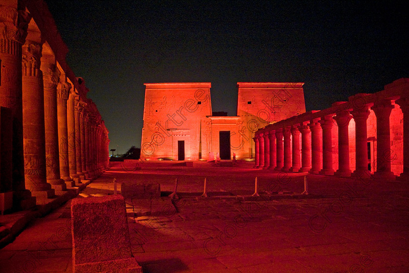 Philae Light Show EG052877JHP 
 Philae Temple Light Show Panorama Entrance West East Colonnade Pylon Night at Aswan in which, during the first section, spectators walk through the temple with areas highlighted at each stop but the time to take photographs is limited. The second part of the evening is seated and photography is very easy, a tripod is permitted and necessary for time exposures to be made as flash on cameras is almost pointless and more of a nuisance for other viewers. This Sound & Light Show is perhaps the most spiritual of those shown at other centres especially with the trip at night by boat to the island and the peacefulness that naturally surrounds this location. 
 Keywords: Egypt, Egyptian, Aswan, River Nile, Agilkia Island, island, Philae, temple, light, sound, show, pylon, landscape, colonnade, court, entrance, Son, Lumiere, spectacular, fantasy, dramatic, night, dark, stars, red, colours, colors, colourful, colorful, spiritual, surreal